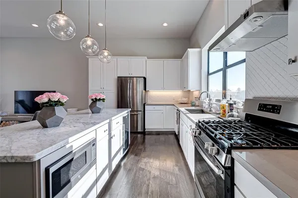 a large kitchen with a table and chairs