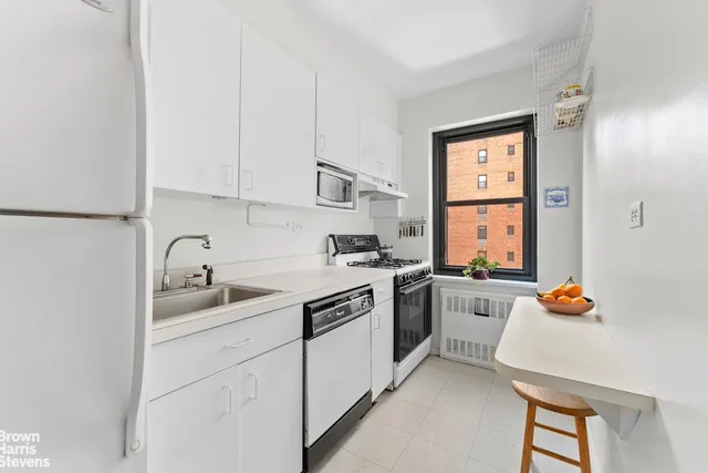 a kitchen with a sink cabinets and appliances