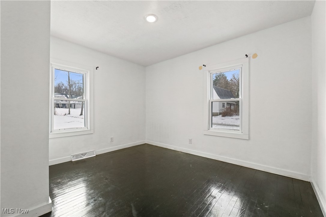 34549 Detroit Road Avon, OH 44011 - Photo 25 of 50 1st floor bedroom featuring dark wood finished floors and healthy amount of natural light