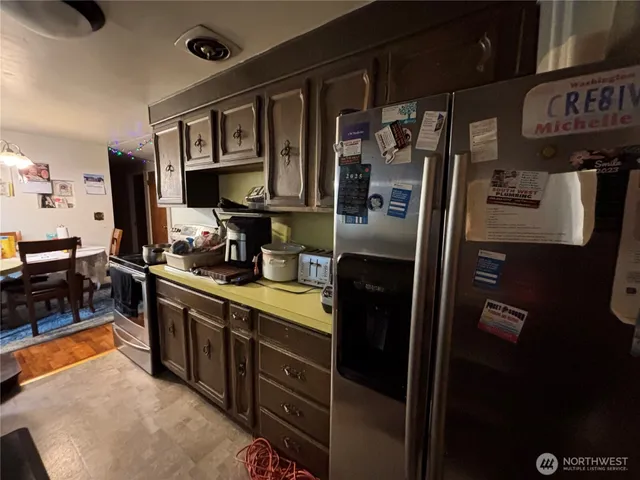 a kitchen with stainless steel appliances granite countertop a refrigerator and a stove