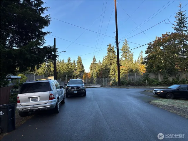 a view of street with parked cars