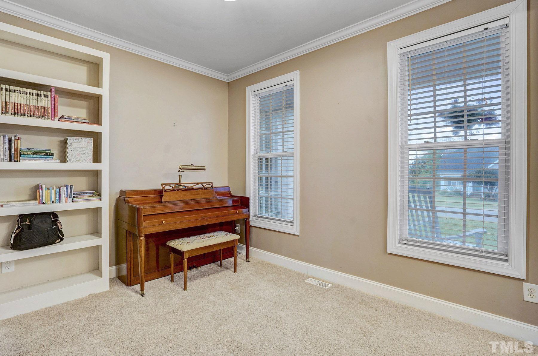 4933 Contender Drive Raleigh, NC 27603 - Photo 11 of 37 a room with a chair and a window