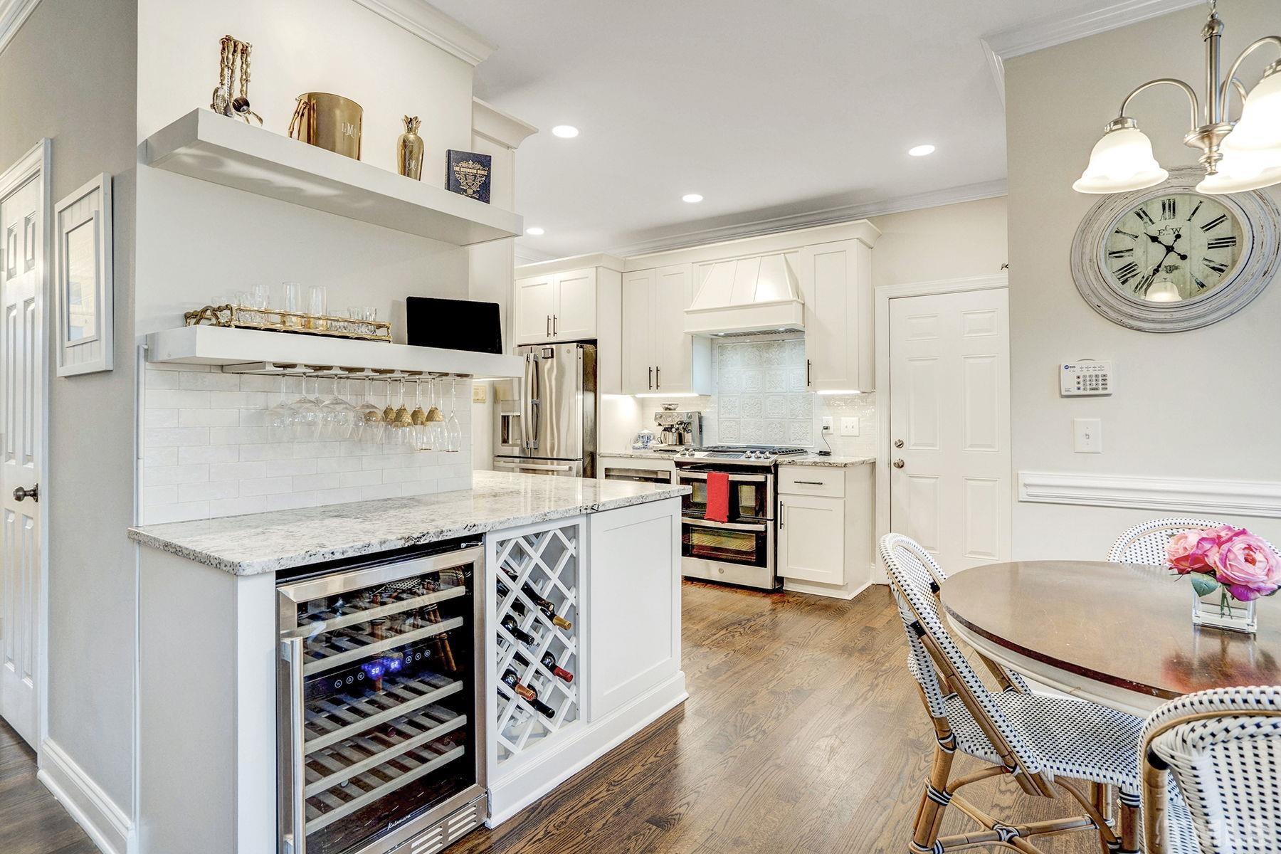 4933 Contender Drive Raleigh, NC 27603 - Photo 17 of 37 a kitchen with a cabinets and chairs
