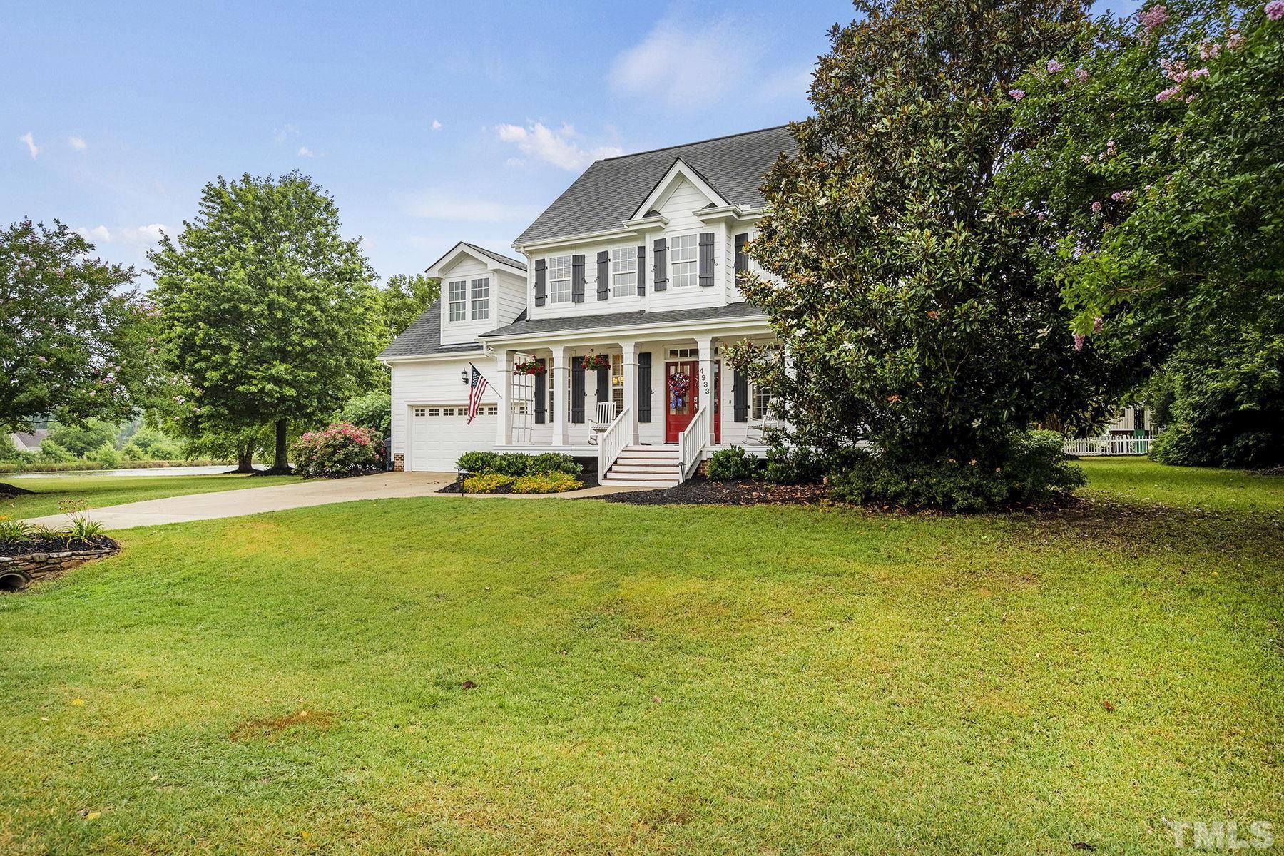 4933 Contender Drive Raleigh, NC 27603 - Photo 6 of 37 a front view of a house with garden