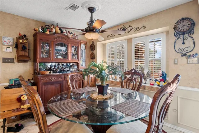 a view of a dining room with furniture a chandelier and wooden floor