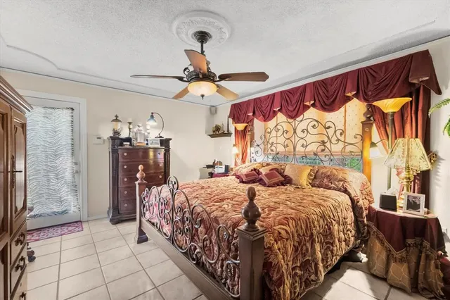 a bedroom with a large bed and a chandelier