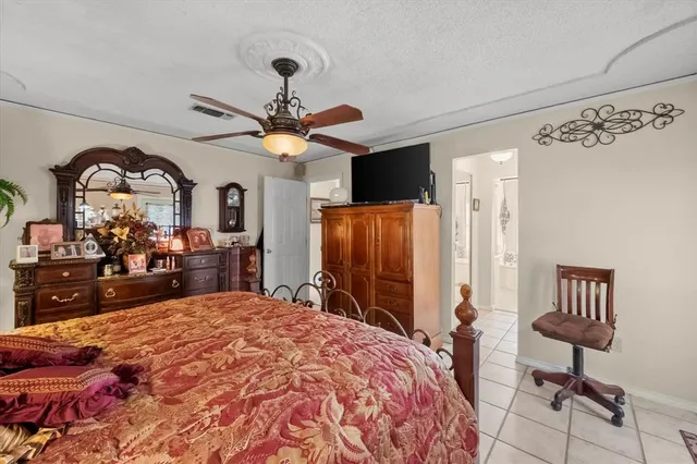 a bed room with a bed mirror and a chandelier
