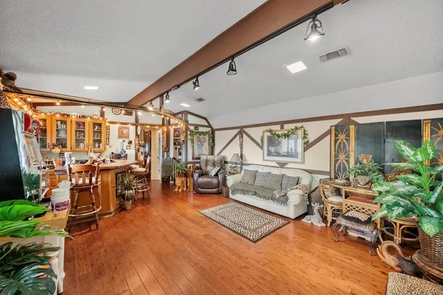 a living room with patio furniture and a large window