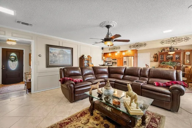a living room with furniture a rug and a painting