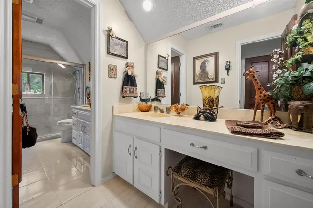 a spacious bathroom with a double vanity sink a mirror and a shower