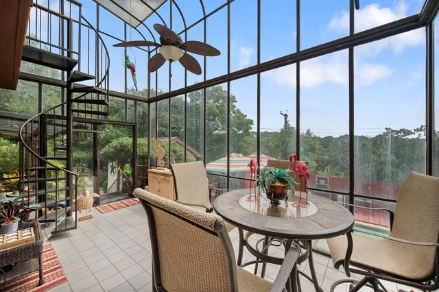 a view of a room with furniture and floor to ceiling windows