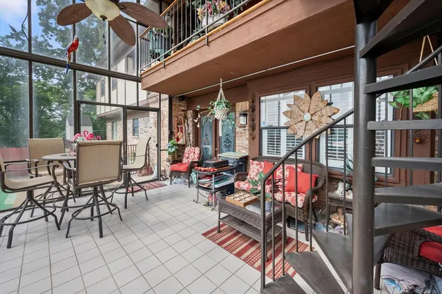 an outdoor space with lots of tables and chairs