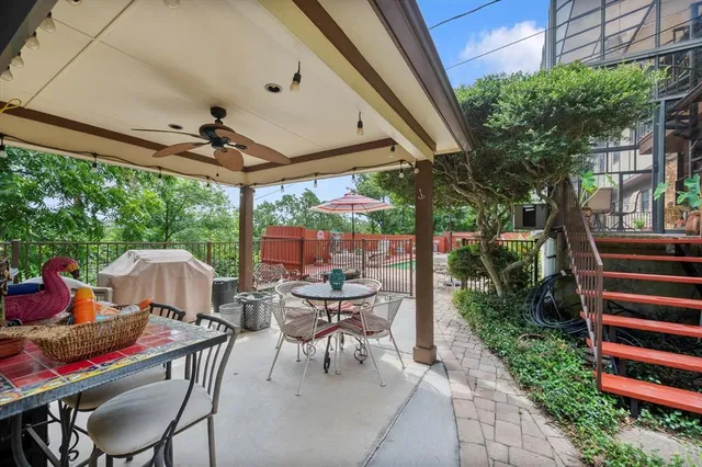 a view of a patio with a table chairs and a backyard