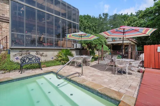 an outdoor space with patio and white umbrellas