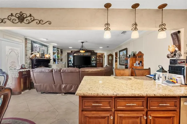 a living room with granite countertop furniture and a flat screen tv