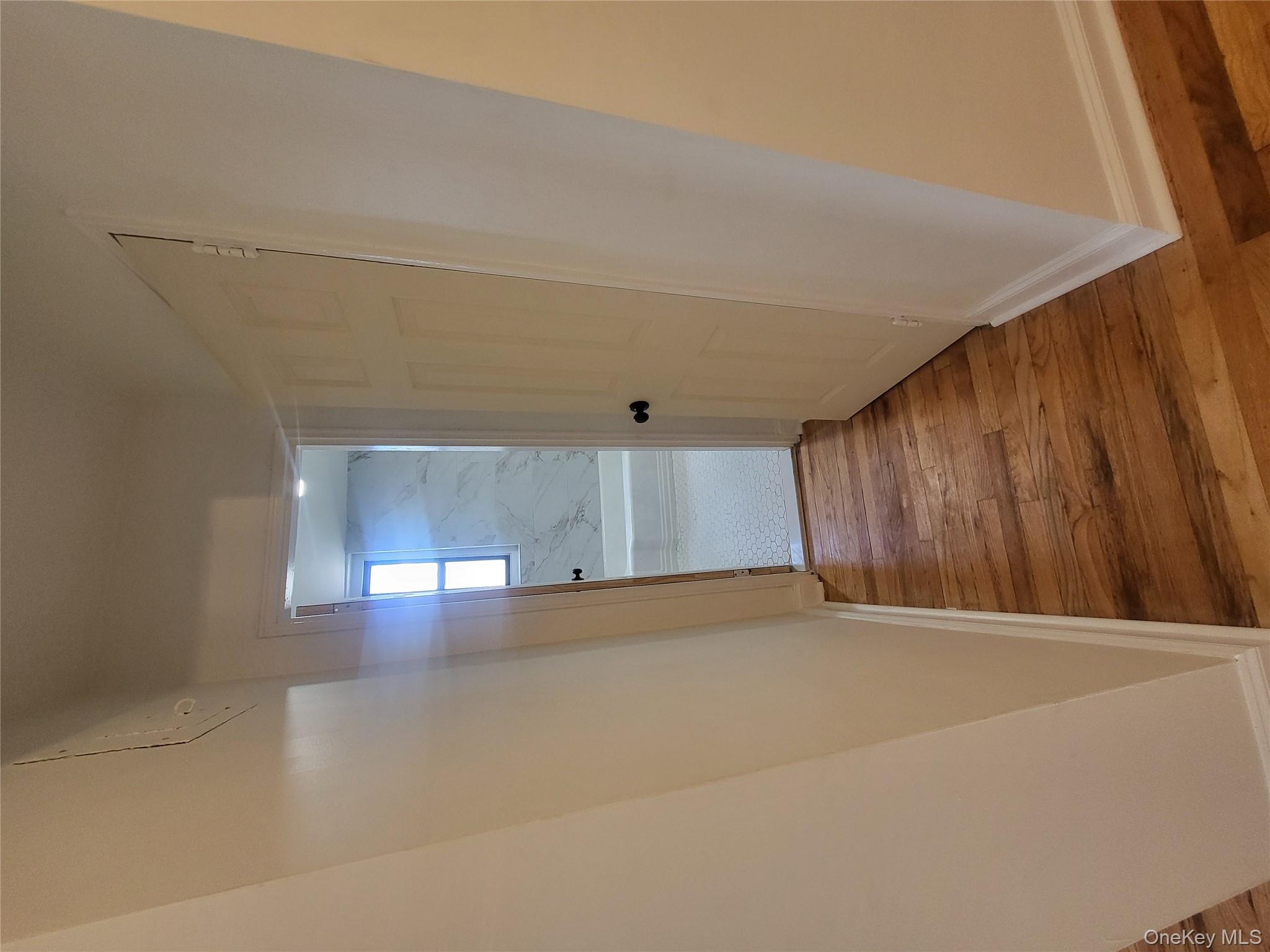 Undisclosed Address Queens, NY 11423 - Photo 11 of 22 Hall with baseboards and light wood finished floors
