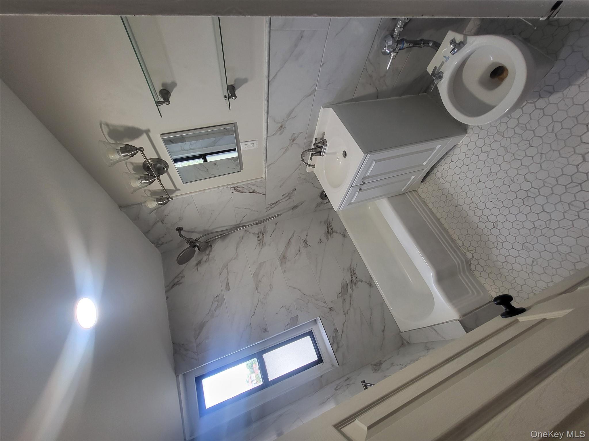 Undisclosed Address Queens, NY 11423 - Photo 12 of 22 Bathroom featuring tile walls, vanity, and shower / washtub combination