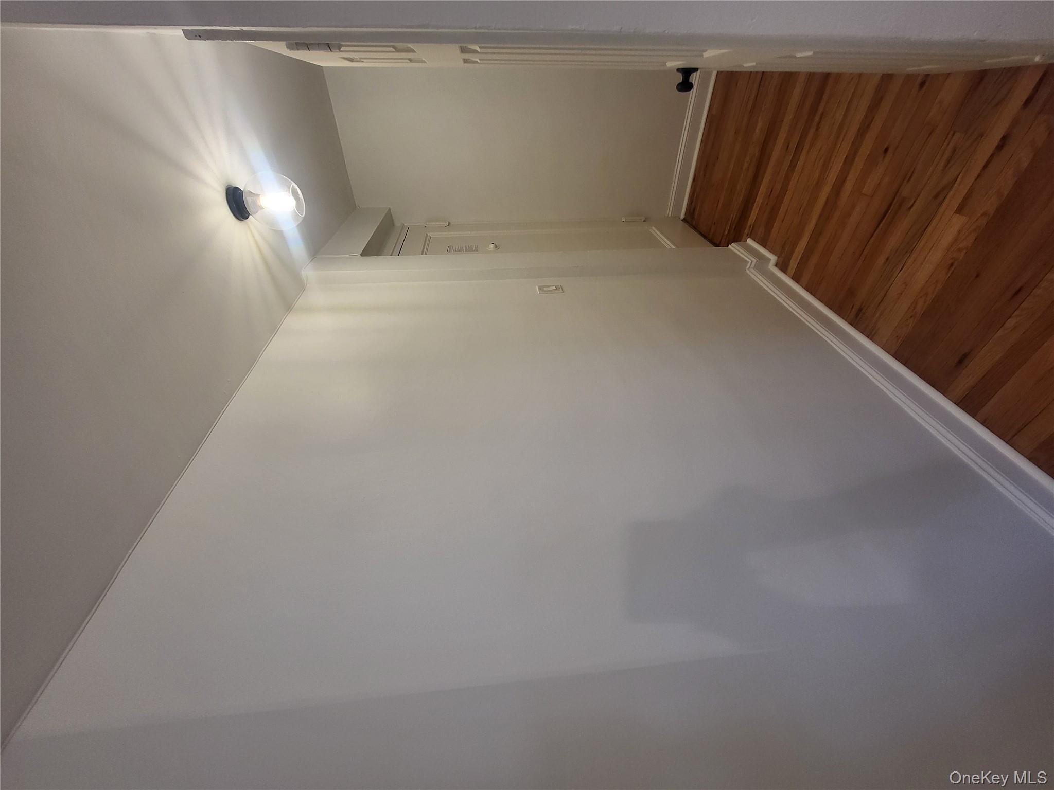 Undisclosed Address Queens, NY 11423 - Photo 15 of 22 Hallway featuring baseboards and dark wood finished floors