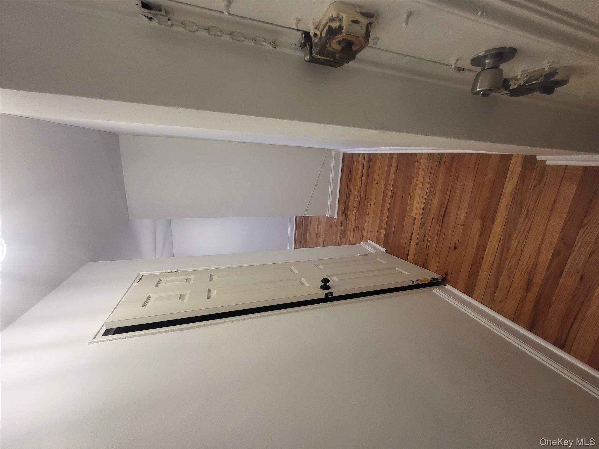 Undisclosed Address Queens, NY 11423 - Photo 16 of 22 Hall featuring baseboards and dark wood-style floors