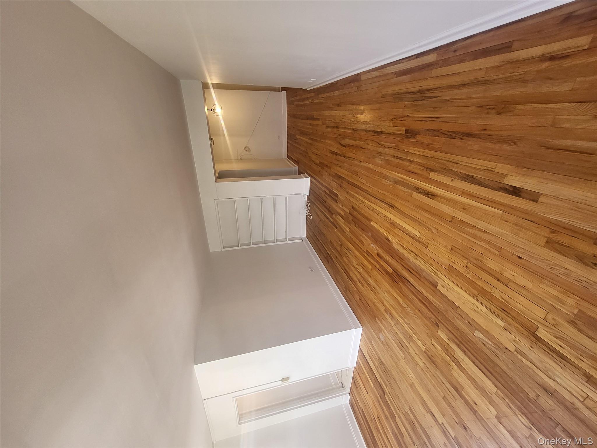 Undisclosed Address Queens, NY 11423 - Photo 10 of 22 Unfurnished bedroom with light wood-style flooring