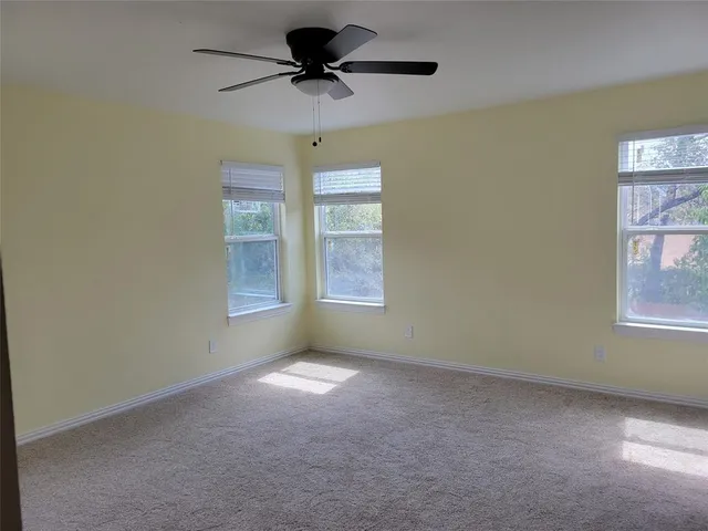 a bathroom with a granite countertop toilet sink and mirror