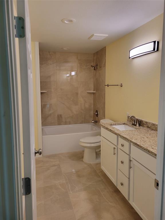 4714 Frank Street Dallas, TX 75210 - Photo 19 of 22 a bathroom with a granite countertop sink a toilet and shower