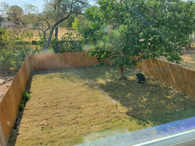 a view of a yard with a tree