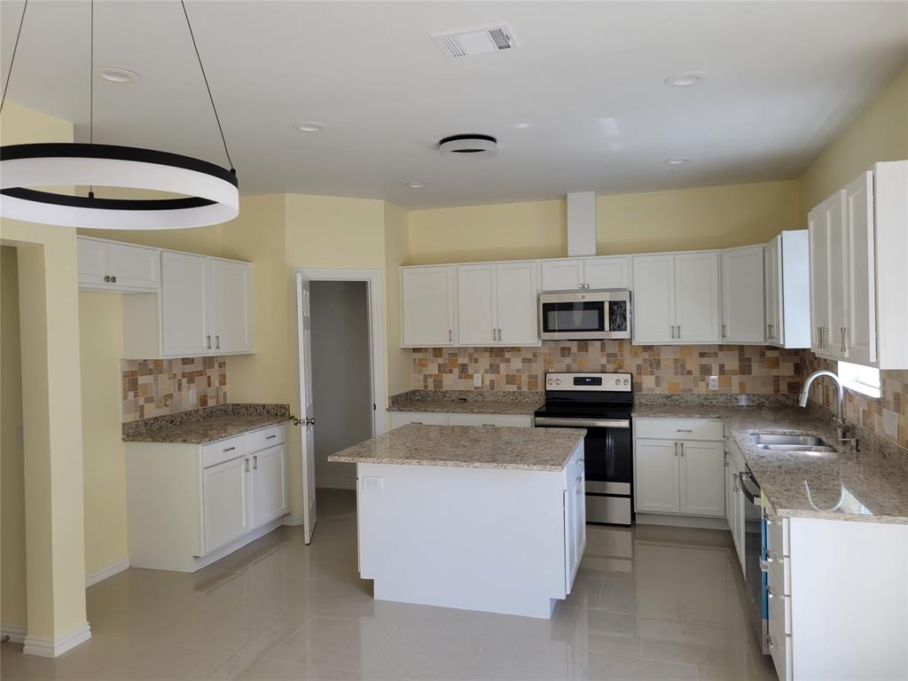 4714 Frank Street Dallas, TX 75210 - Photo 3 of 22 a kitchen with a sink stove and refrigerator
