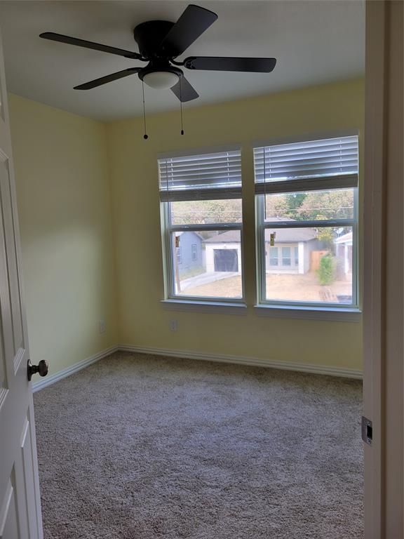 4714 Frank Street Dallas, TX 75210 - Photo 7 of 22 a room with a window and a ceiling fan