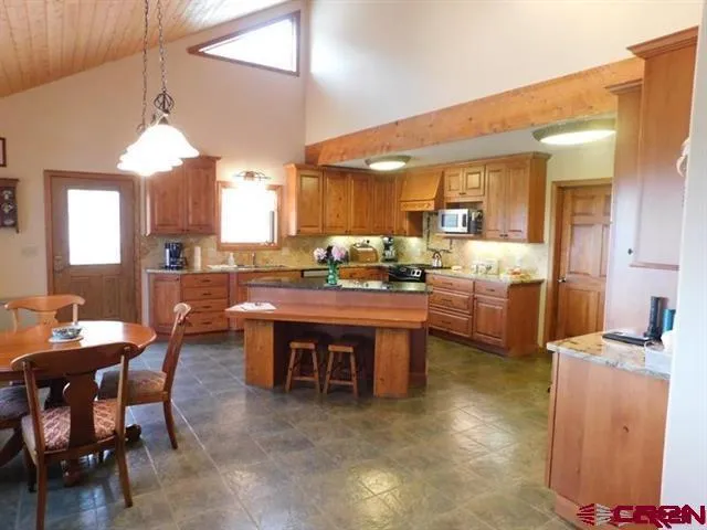 a room with stainless steel appliances kitchen island granite countertop furniture and a kitchen view