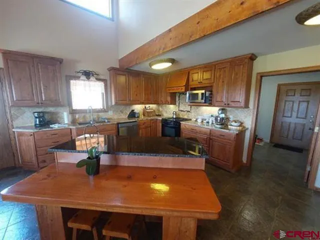 a kitchen with a table chairs and a refrigerator