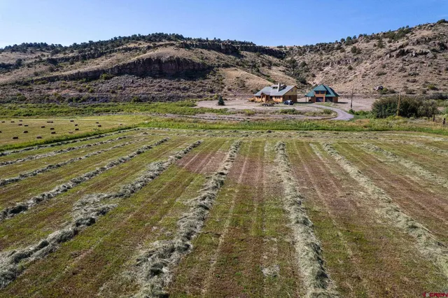 a view of swimming pool with a yard and mountain view