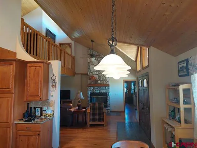 a bedroom with a bed and a mirror on dresser