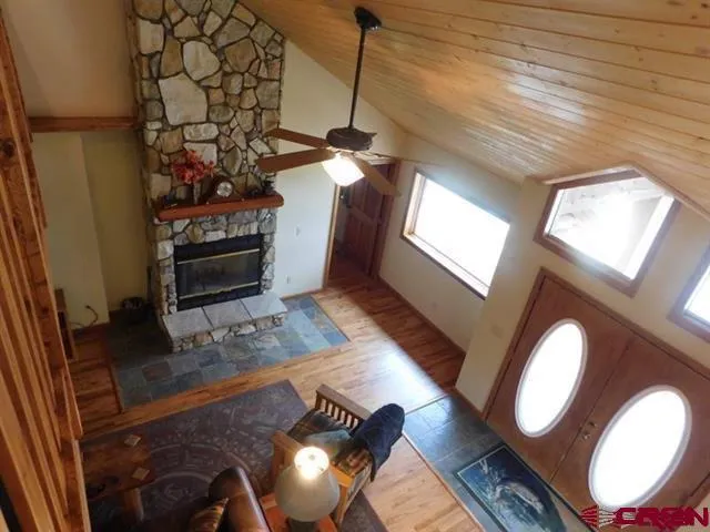 a bed sitting in a spacious bedroom next to a window