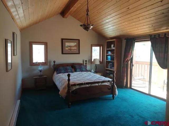 a spacious bedroom with a bed and a window