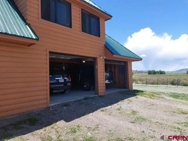 a work room with furniture and a potted plant