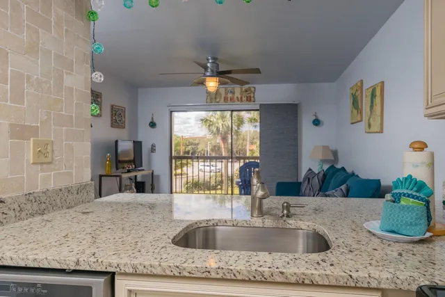 a kitchen with granite countertop a sink and a window