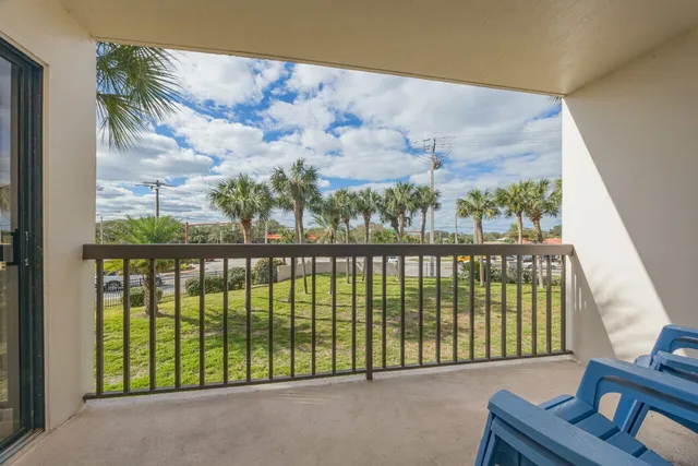 a view of a balcony with furniture