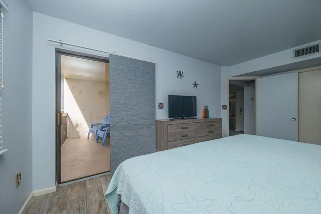 a bedroom with a bed and a flat screen tv