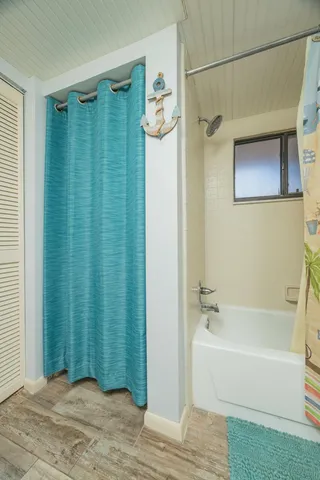 a bathroom with a bathtub and shower