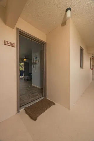 a view of a hallway view with wooden floor and staircase