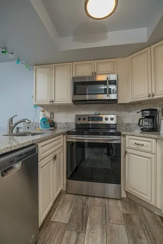 a kitchen with granite countertop a stove and a sink