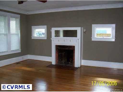 13082 Corinth Road Ivor, VA 23866 - Photo 4 of 7 a view of empty room with wooden floor and a fireplace
