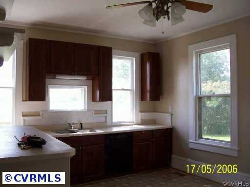 13082 Corinth Road Ivor, VA 23866 - Photo 5 of 7 a kitchen with a sink window and cabinets