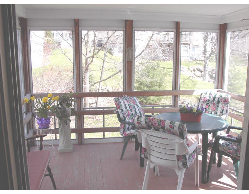 25 Maple Ridge Road Reading, MA 01867 - Photo 4 of 5 a dining room with wooden floor and a floor to ceiling window