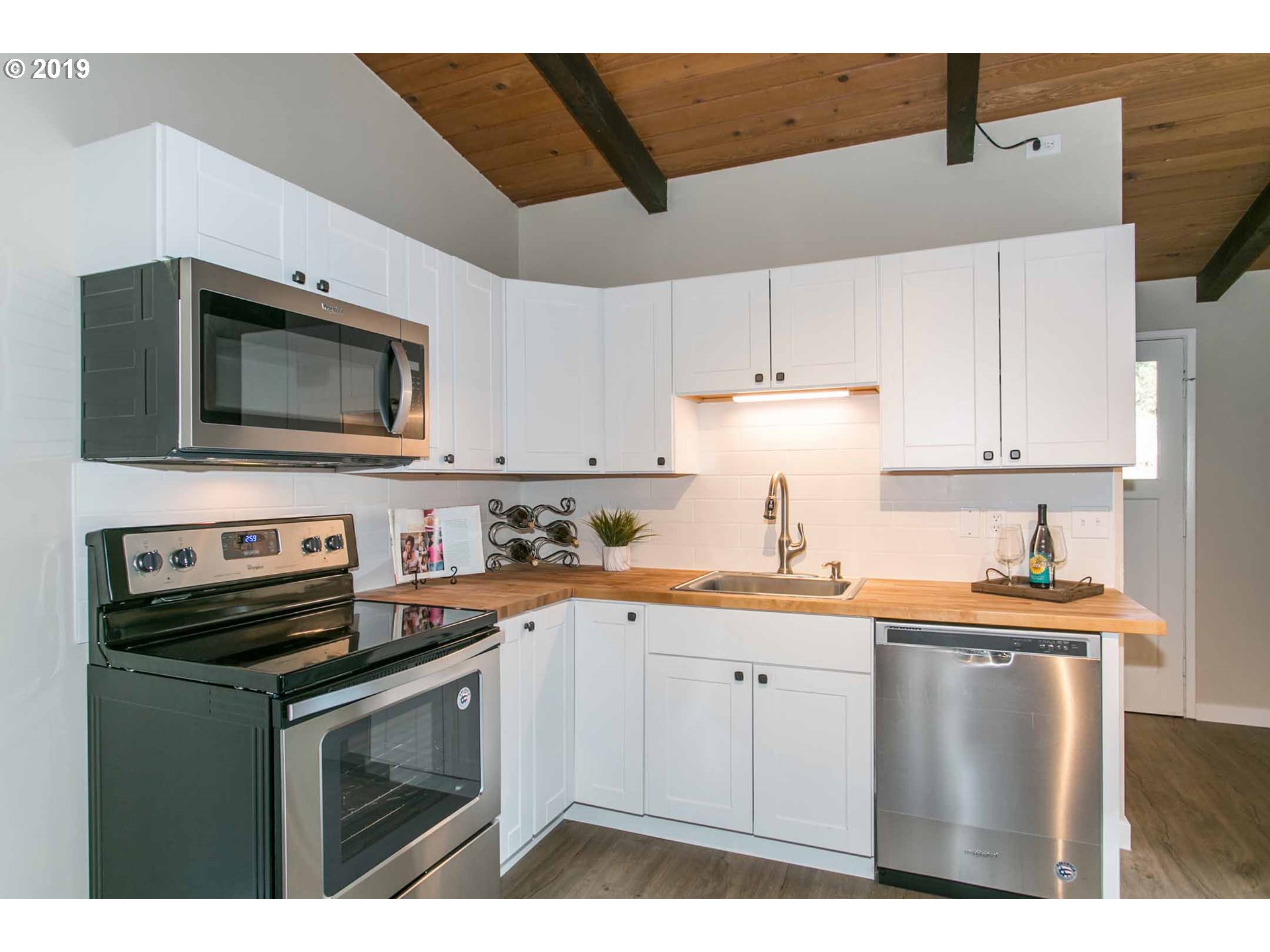 13010 South Union Hall Road Canby, OR 97013 - Photo 11 of 31 a kitchen with stainless steel appliances a sink a stove a microwave a sink and cabinets