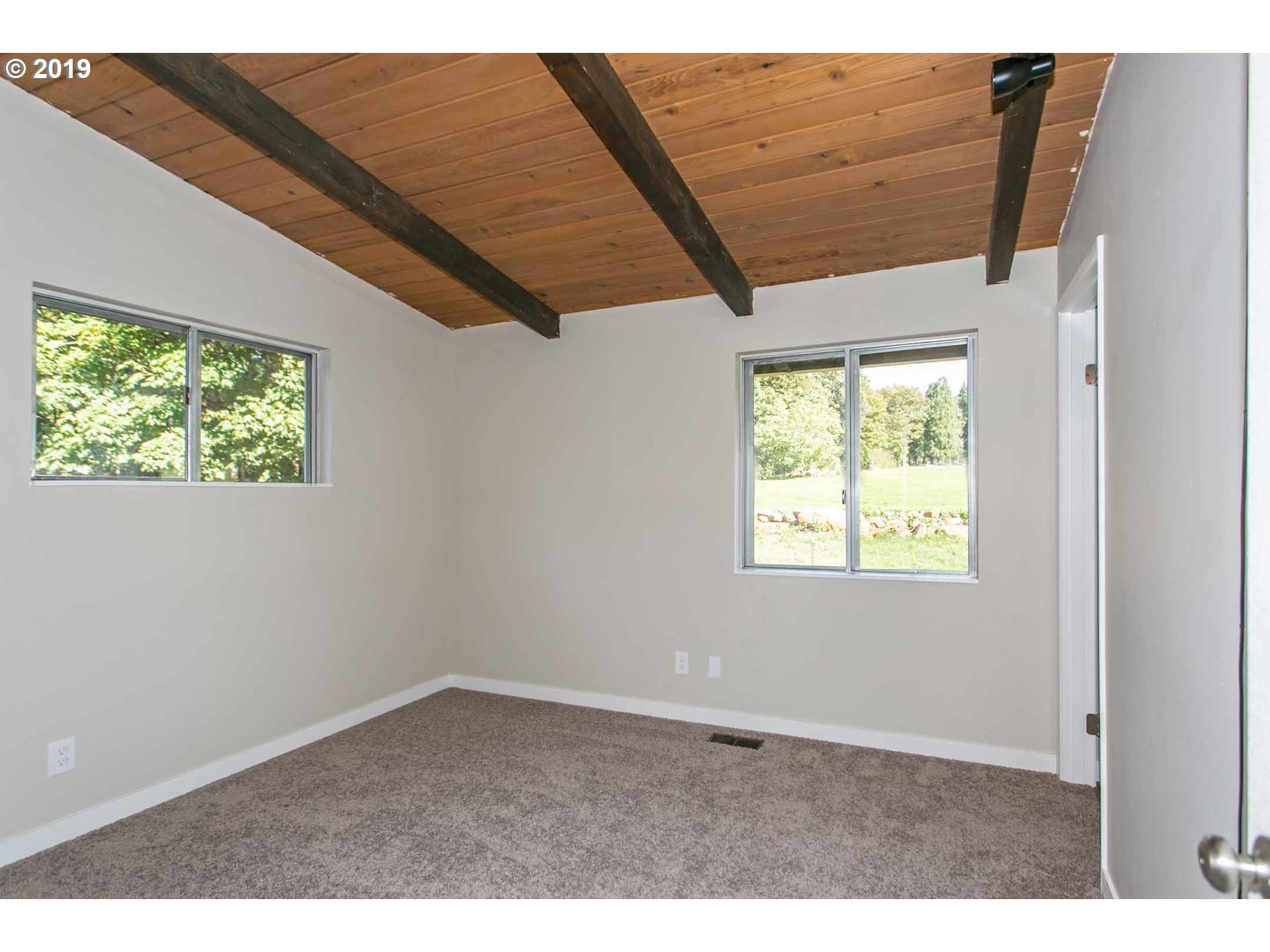 13010 South Union Hall Road Canby, OR 97013 - Photo 13 of 31 an empty room with wooden floor and windows
