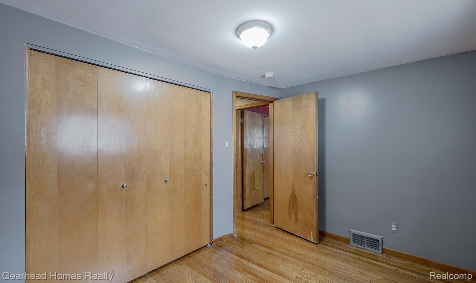 3356 Harding Street Dearborn, MI 48124 - Photo 25 of 48 Wood-finish flooring with light gray walls and a flush-mount ceiling light