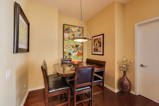 a dining room with furniture and wooden floor