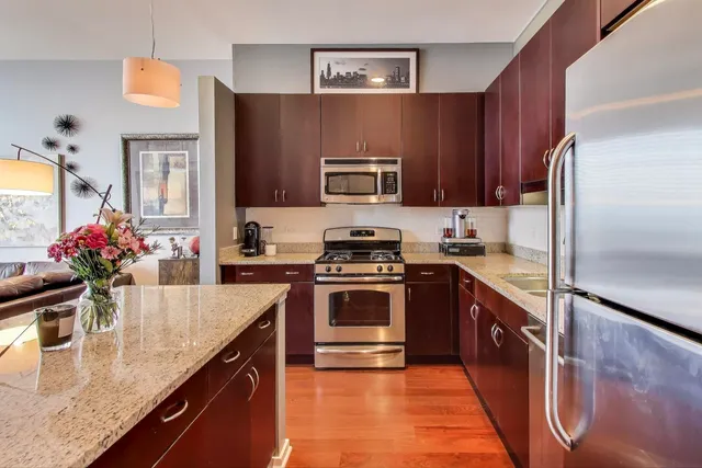 a bedroom with a bed and a lamp on dresser